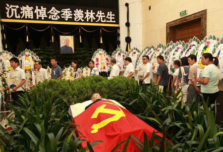People mourn in the farewell ceremony of renowned Chinese scholar Ji Xianlin in Beijing, China, July 19, 2009. The funeral of Ji Xianlin was held in Bejing on Sunday. Ji Xianlin died of illness at the age of 98 in Beijing on July 11, 2009. He was a well-known linguist, translator and researcher on Indian literature and history.