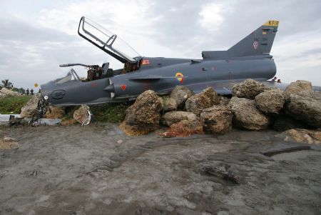 Picture taken on July 20, 2009 shows the Kfir fighter plane crash site at an airport in Cartagena, Colombia. Two pilots aboard the plane survived the accident on Monday.