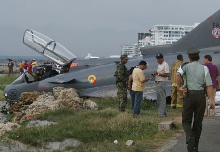 Investigators inspect the Kfir fighter plane crash site at an airport in Cartagena, Colombia, on July 20, 2009. Two pilots aboard the plane survived the accident Monday. 