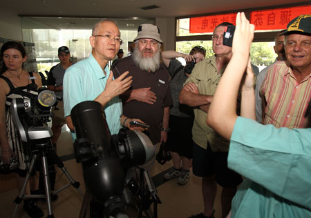 A group of Australian tourists visit a local telescope-making factory prior to the total solar eclipse observation at Suzhou City in east China's Jiangsu Province, on July 20, 2009.