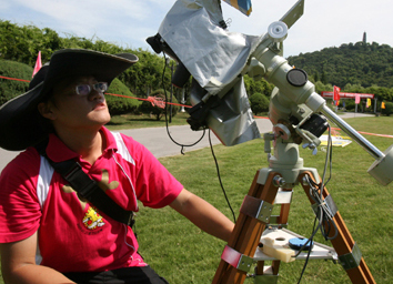An astronomy enthusiast from southeast China&apos;s Taiwan tests his solar eclipse observation instruments in the Shangfangshan Forest Park in Suzhou, east China&apos;s Jiangsu Province, on July 20, 2009. A big number of astronomers and astronomy enthusiasts have arrived at Shangfangshan Forest Park in Suzhou, preparing for solar eclipse observation on July 22. 