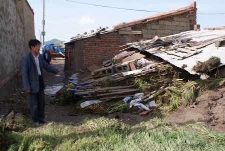 A resident looks at his collapsed house on July 21, 2009 after a heavy rainstorm hit Maqu County in northwest China's Gansu Province, killing at least five people. 