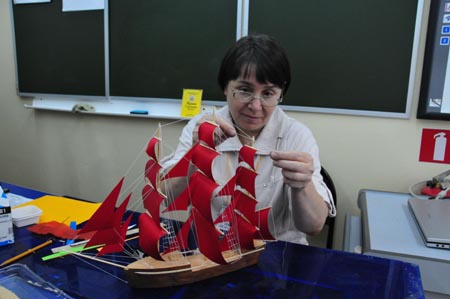 A staff member makes a model of a boat at a children's center in preparation to welcome the students from China's earthquake-hit areas in Vladivostok, Russia, on July 22, 2009.