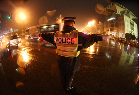 A traffic policeman works on the illuminated road when full solar eclipse occurred over east China's Shanghai, on July 22, 2009. As full solar eclipse occured, the city illumination of main roads and airports were switched on for safe traffic.