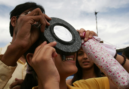 Nepali astronomy enthusiasts observe the solar eclipse in Kathmandu, capital of Nepal, on July 22, 2009.