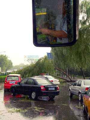 Vehicles and cyclists drive in water after a heavy rain hit Beijing, capital of China, on July 22, 2009. A summer heavy rain hit China&apos;s capital city on Wednesday evening.