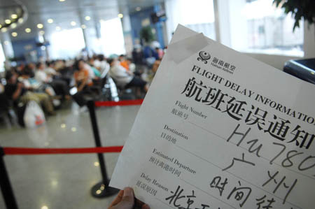 A flight delay information is shown to passengers at Beijing Capital International Airport as flights were delayed due to strong wind in a heavy rainfall in Beijing, capital of China, on July 22, 2009. A heavy rainfall hit China&apos;s capital city on Wednesday evening.