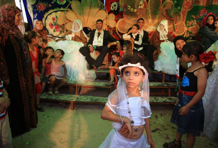 People attend a wedding ceremony, after which the newly-wedded couple will live in a tent as temporary shelter because their house was destroyed during Israel&apos;s recent offensive at the border town of Beit Hanoun in the Gaza Strip, on July 22, 2009.