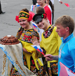 Russian youth, with the bread and salt, welcome students from China's earthquake areas at the 'Ocean' All-Russia Children's Care Center in Vladivostok, Russia, on July 23, 2009.