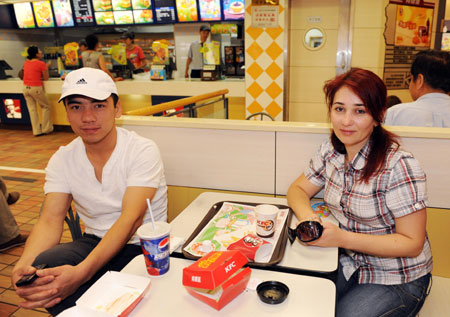 A couple from Uzbekistan eat at the KFC store in the international bazar in Urumqi, capital of northwest China's Xinjiang Uygur Autonomous Region, on July 23, 2009. The KFC store in the international bazar, which was closed after the July 5 riot, was reopened on Thursday.