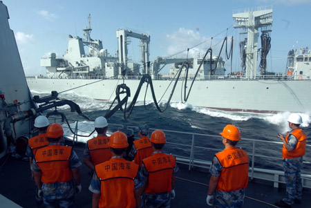 Chinese naval 'Zhoushan' missile frigate receives replenishment from 'Qiandaohu' supply ship (Back) at sea on July 25, 2009. The third Chinese fleet en route to the Gulf of Aden and waters off Somalia for an escort mission against pirates completed its second and lateral replenishment at sea on Saturday.