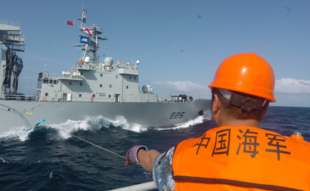 Chinese naval 'Zhoushan' missile frigate receives replenishment from 'Qiandaohu' supply ship (rear) at sea on July 25, 2009.