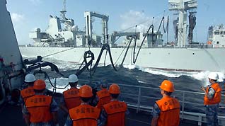 Chinese naval 'Zhoushan' missile frigate receives replenishment from 'Qiandaohu' supply ship (Back) at sea on July 25, 2009. The third Chinese fleet en route to the Gulf of Aden and waters off Somalia for an escort mission against pirates completed its second and lateral replenishment at sea on Saturday.