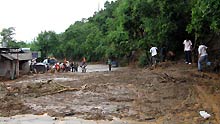 Photo taken on July 27, 2009 shows the provincial road 214 damaged by the mudslide at Miyi County, Panzhihua City, southwest China's Sichuan Province. Twenty-two people are dead and seven missing after torrential rains triggered floods in Miyi County, local authorities said on Monday.