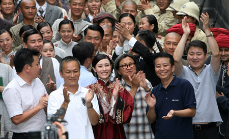 People celebrate on the closing ceremony of Chinese movie 'Bodyguards and Assassins' in Shengqiang Film and TV Base in Shanghai, China, on July 27, 2009. The Chinese movie 'Bodyguards and Assassins' has wrapped up and will debut in December.