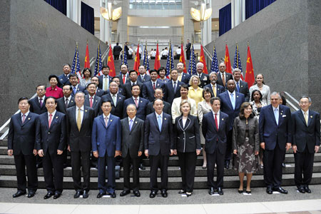 Chinese Vice Premier Wang Qishan (6th L, Front), State Councilor Dai Bingguo (5th L, Front), US Secretary of State Hillary Clinton (5th R, Front), US Treasury Secretary Timothy Geithner (4th R, Front) and other officials pose for a group photograph before the opening ceremony of the China-US Strategic and Economic Dialogue in Washington, the United States, on July 27, 2009.
