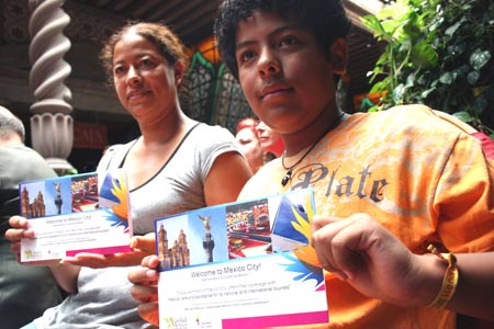 Tourists display their facilitated meidcal card in Mexico City, Mexico, on July 28, 2009. The Mexican government on Tuesday issued facilitated meidcal cards to 10 tourists who could receive flu prevention mesures, treatments and emergency relief with little payments.