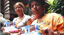 Tourists display their facilitated meidcal card in Mexico City, Mexico, on July 28, 2009. The Mexican government on Tuesday issued facilitated meidcal cards to 10 tourists who could receive flu prevention mesures, treatments and emergency relief with little payments.