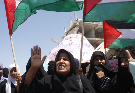 Palestinians attend a protest calling the lifting of the Israeli blockade in Rafah, southern Gaza Strip, on July 29, 2009. UN agencies called on Israel to allow construction materials into the Gaza Strip so that schools damaged in this year's war can be rebuilt in time for the new school year. 