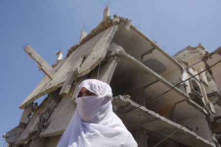 A Palestinian woman attends a protest calling the lifting of the Israeli blockade in Rafah, southern Gaza Strip, on July 29, 2009. 