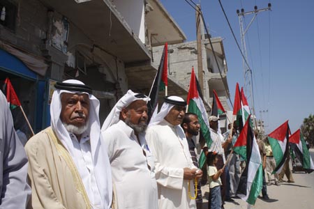 Palestinians whose houses were destroyed during Israel's offensive in Gaza attend a protest calling for the rebuilding of the houses, in the Rafah refugee camp, southern Gaza Strip, July 29, 2009. Thousands of homes were damaged or destroyed during Israel's 23-day military offensive launched on Dec.27, 2008. 