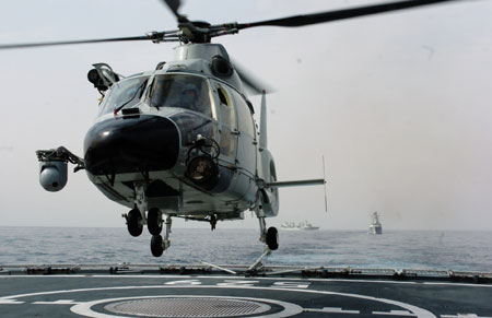 Carrier-based helicopter takes off from Zhoushan missile frigate before joining the Second Chinese naval escort on the Gulf of Aden, on July 30, 2009. Two frigates and a supply ship from the Chinese navy, on another escort mission to fend off Somali pirates, joined with the second naval escort on Thursday.