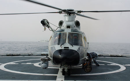 Carrier-based helicopter takes off from Zhoushan missile frigate before joining the Second Chinese naval escort on the Gulf of Aden, on July 30, 2009. Two frigates and a supply ship from the Chinese navy, on another escort mission to fend off Somali pirates, joined with the second naval escort on Thursday. 