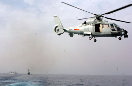 Carrier-based helicopter takes off from Zhoushan missile frigate before joining the Second Chinese naval escort on the Gulf of Aden, on July 30, 2009. Two frigates and a supply ship from the Chinese navy, on another escort mission to fend off Somali pirates, joined with the second naval escort on Thursday.