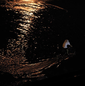 A man rides bike on a flooded street in Beijing, capital of China, on July 31, 2009. A heavy rain hit Beijing on Thursday evening and caused traffic jam. 