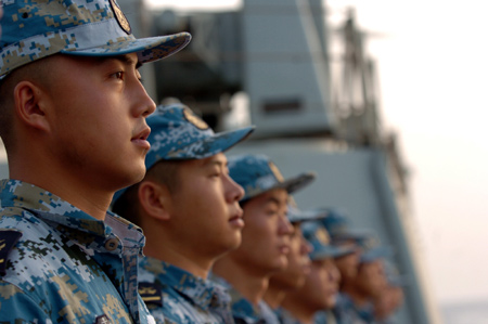 Crew members of the missile frigate 'Zhoushan' of the third Chinese naval flotilla see off the second Chinese naval flotilla in the Gulf of Aden on August 2, 2009. The third Chinese naval flotilla for escorting mission started to protect merchant vessels from pirates in the Aden Gulf on August 1.