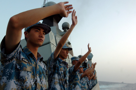 Crew members of the missile frigate 'Zhoushan' of the third Chinese naval flotilla see off the second Chinese naval flotilla in the Gulf of Aden on August 2, 2009. 