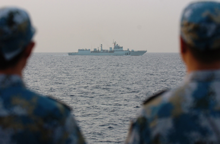 Crew members of the missile frigate 'Zhoushan' of the third Chinese naval flotilla see off the destroyer 'Shenzhen' of the second Chinese naval flotilla in the Gulf of Aden on August 2, 2009.