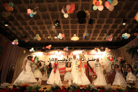 Palestinian children, dressed in bride clothes, sing during a collective wedding party which involved 80 grooms and brides in Gaza city on August 2, 2009. The Islamic Palestinian factions Hamas increased collective wedding parties following the end of Israel's recent military offensive to help victims and handicapped marry easily. 