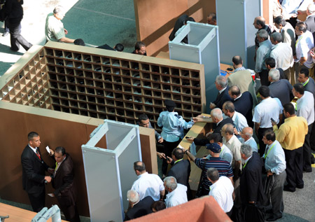 Delegates wait to pass the security check at the assembly place of the sixth congress of the Palestinian Fatah movement in the West Bank city of Bethlehem on August 4, 2009. 