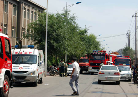 Rescue vehicles await orders near the venue of ammonia leakage accident in Chifeng City of north China's Inner Mongolia Autonomous Region, on August 5, 2009.