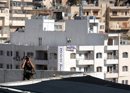 Palestinian policemen guard near the assembly place of the sixth congress of the Palestinian Fatah movement in the West Bank city of Bethlehem, on August 4, 2009.