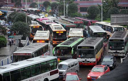 Vehicles are blocked during rush hour in China's Chongqing Municipality, Aug. 4, 2009. Heavy rain hit Chongqing on Tuesday causing traffic jam and the closure of highways. A total of 379,900 people are plagued by the strong rainfalls.