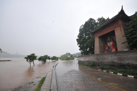 The swollen river approaches a temple on the Binjiang Road in southwest China's Chongqing Municipality, on August 4, 2009. The continual heavy rainfalls in Chongqing brought about flood over the city, with many lower sections of the riverside streets submerged.