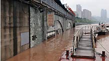 The houses along the Nanbin Road are inundated by rainfalls in southwest China's Chongqing Municipality, on August 4, 2009. The continual heavy rainfalls in Chongqing brought about flood over the city, with many lower sections of the riverside streets submerged.