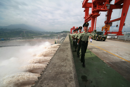 The armed policemen patrol on the top of the Three Gorges Dam in Yichang City of central China's Hubei Province, on August 6, 2009.