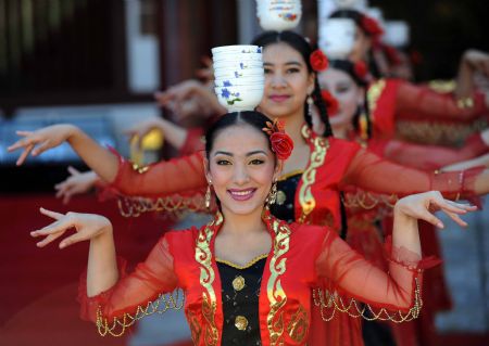 Actresses perform dance during a tourism promotion ceremony at the Tianchi Lake in the Tianshan Mountains of northwest China&apos;s Xinjiang Uygur Autonomous Region, on August 8, 2009. 