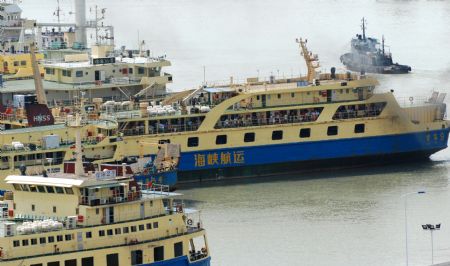 A passenger liner leaves Xiuying port in Haikou, capital of south China's Hainan Province, on August 8, 2009. Shipping services across south China's Qiongzhou Strait, separating the Hainan island and the mainland, resumed Saturday afternoon as tropical storm 'Goni' churned southward.