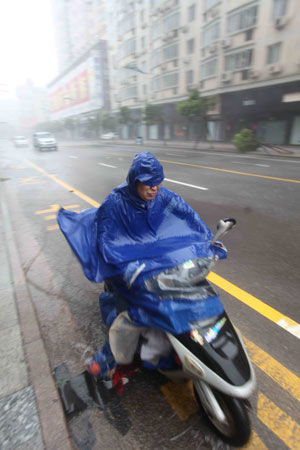 A Chinese motorcyclist drives against heavy rain and wind hours prior to the landing of typhoon Morakot at Rui'an City in east China's Zhejiang Province on August 9, 2009. Typhoon Morakot gains momentum and is expected to hit provinces in east China later Sunday.