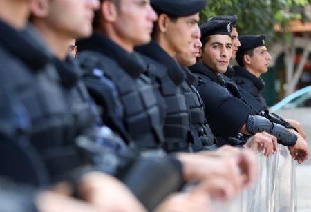 Palestinian security forces stand guard near the site of the election for Fatah movement's central committee and revolutioary council, in the West Bank city of Bethlehem on August 9, 2009. 