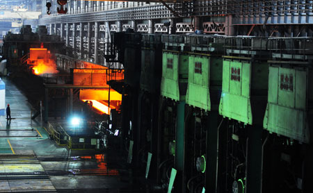 Workers work at a workshop of Anshan Iron and Steel Group Corporation (Angang) in Anshan, northeast China's Liaoning Province, on August 2, 2009. 