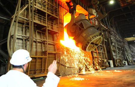 Workers work at a workshop of Anshan Iron and Steel Group Corporation (Angang) in Anshan, northeast China's Liaoning Province, on August 2, 2009. 