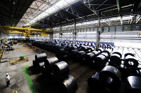 Workers work at a workshop of Anshan Iron and Steel Group Corporation (Angang) in Anshan, northeast China's Liaoning Province, on August 2, 2009. 