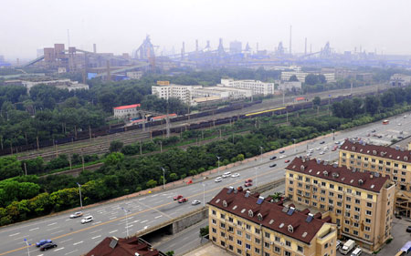 New residential area is seen built beside Anshan Iron and Steel Group Corporation (Angang) in Anshan, northeast China's Liaoning Province, on August 2, 2009. 