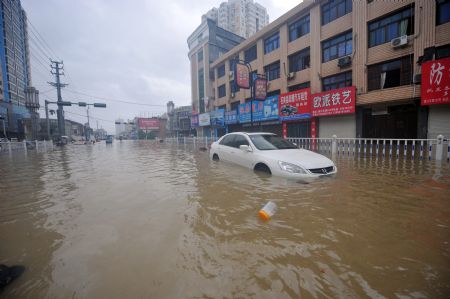 A car is immerged in flood in Cangnan, east China's Zhejiang Province, on August 10, 2009.