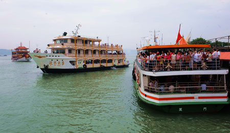 Feeryboats are seen near the harbor in Xiamen, southeast China's Fujian Province, on August 10, 2009. The navigation in Xiamen restored after Typhoon Morakot left the area.